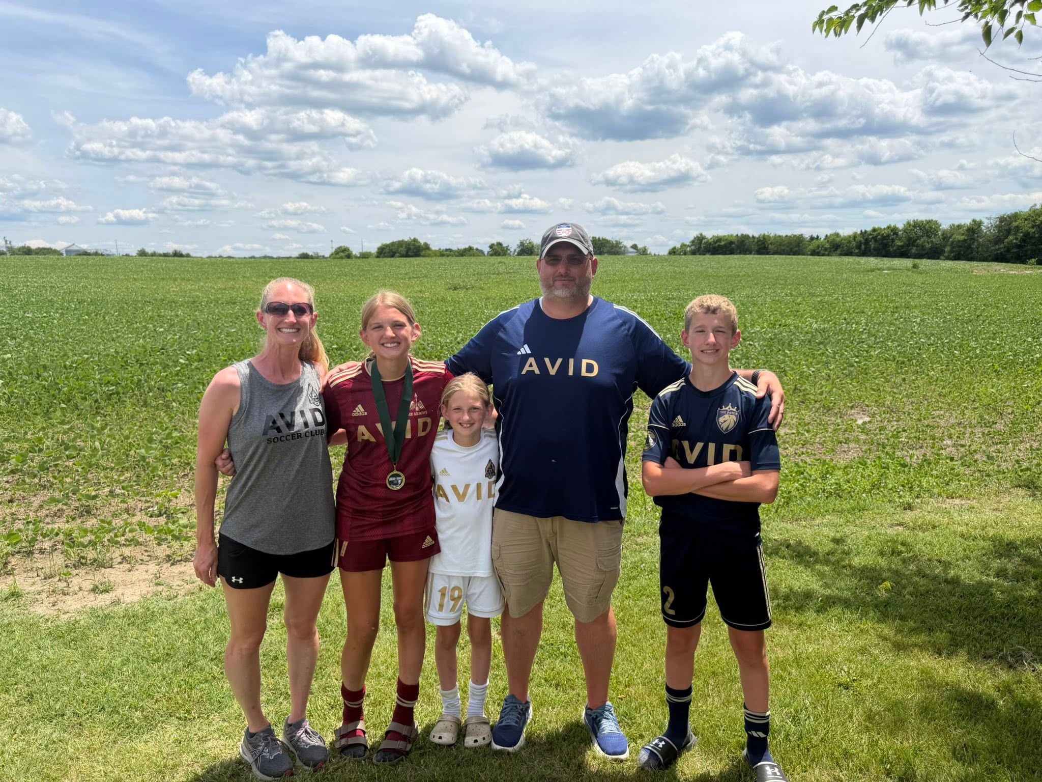 Daren Sipes with his family in AVID soccer gear on a field
